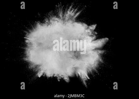 Bizarre forms of white powder explosion cloud against black background. Stock Photo