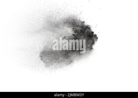 Black powder explosion on white background.Black dust particles splash. Stock Photo