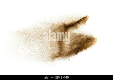 Dry river sand explosion. Golden colored sand splash against white background. Stock Photo