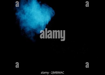 Blue color powder explosion cloud  on black background.Closeup of Blue dust particles exhale on dark Stock Photo