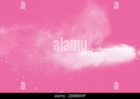 White powder explosion on pink background. Stock Photo