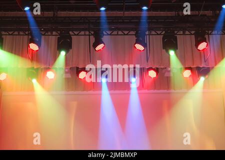 Stage with colorful lighting equipment. Multi-colored spotlights above the stage Stock Photo