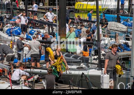 crews and owners on the pontoons in cowes yacht have during the annual cowes week yachting regatta on the isle of wight, crews making ready for racing Stock Photo