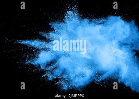 Bizarre forms of  blue powder explode cloud on background. Launched blue dust particles splashing. Stock Photo