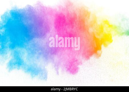 Abstract multi color powder explosion on white background.  Freeze motion of  dust  particles splash Stock Photo