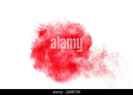 Abstract red dust explosion on white background. Abstract red powder splattered on white  background Stock Photo