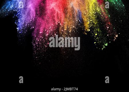 Abstract multi color powder explosion on black background.  Freeze motion of colorful dust  particle Stock Photo