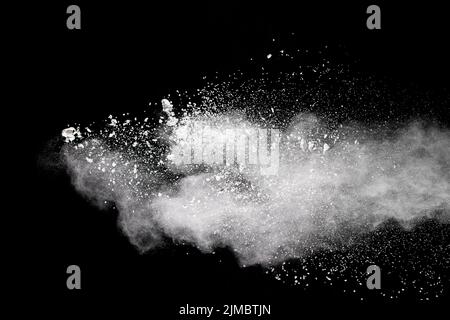 White powder explosion cloud against black background.White dust particles splash Stock Photo