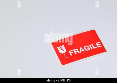 A red Fragile sticker for stick on a parcel isolated on white background. Stock Photo