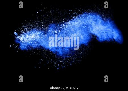 Blue color powder explosion cloud on black background.Closeup of Blue dust particles exhale on dark Stock Photo