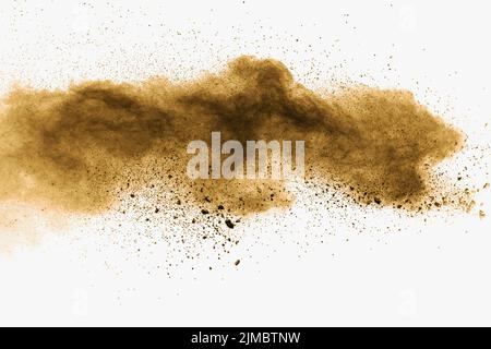 Abstract deep brown dust explosion on white background.  Freeze motion of coffee liked color dust sp Stock Photo