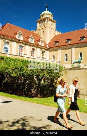 Two women walk on the campus of Harvard University in Cambridge, near Boston, Massachusetts, passing the Busch Reinsinger Natural History Museum Stock Photo