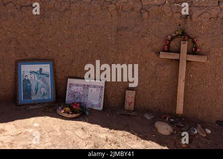 Cross and religious art at Santa Rosa de Lima, an early 18th-century Spanish settlement near Abiquiu, Rio Arriba County, New Mexico, USA. Stock Photo