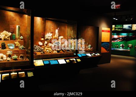 A large display in the Bruce Museum, a natural history and science museum in Greenwich Connecticut, showcases different gems and minerals for guests Stock Photo