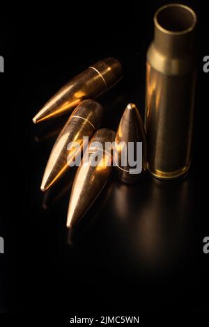 Bullet isolated on black background with reflexion. Rifle bullets close-up on black back. Stock Photo