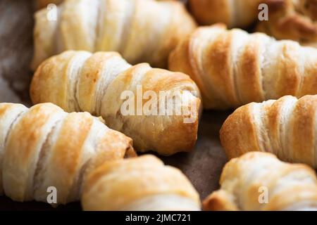 Pigs in a blanket - puff pastry baking with sausages. Stock Photo