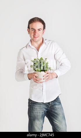 Young man with plant Stock Photo