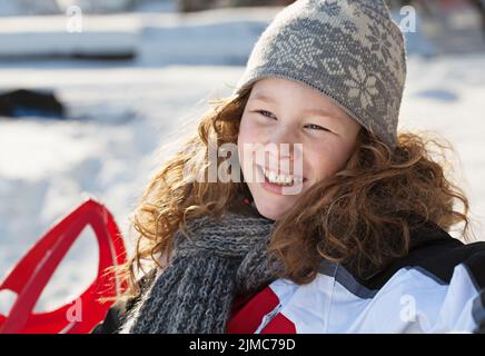 Smiling blond girl in winter park Stock Photo