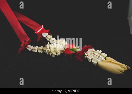 Selected focus Thai traditional jasmine garland. symbol of Mother's day in thailand, to offer the monk or buddha in dark backgro Stock Photo