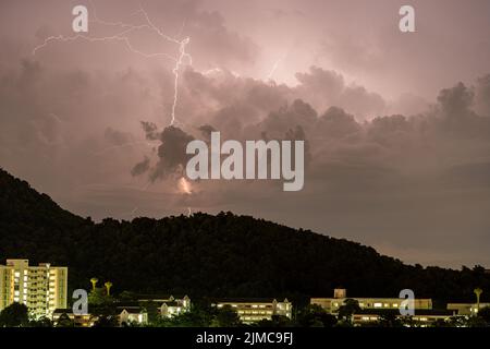 Storm lightning strikes in mountains during a thunderstorm at night. Beautiful dramatic view Stock Photo