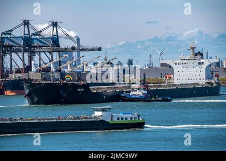 Europoort, Port of Rotterdam, the bulk freighter Hero, loaded with bulk cargo, ore, coal, is towed to the quay, Europoort C.V. Terminal, Netherlands, Stock Photo