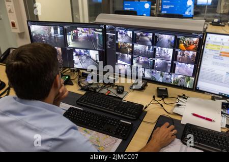 Freiburg, Germany. 05th Aug, 2022. A police officer sits in front of monitors showing live images from several surveillance cameras in Freiburg's city center. The Freiburg police have installed a network of video cameras in a highly frequented area at night, which have now been in operation for a short time. Credit: Philipp von Ditfurth/dpa - ATTENTION: Deployment data pixelated on the monitor/dpa/Ģ����ý Live News Stock Photo