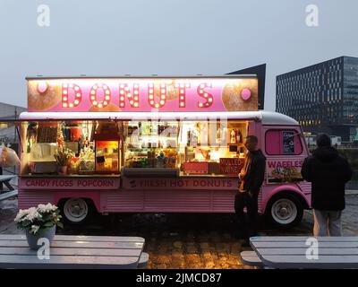 Pink food truck offering donuts and waffles at the Albert Dock waterfront in Liverpool,Great Britain Stock Photo