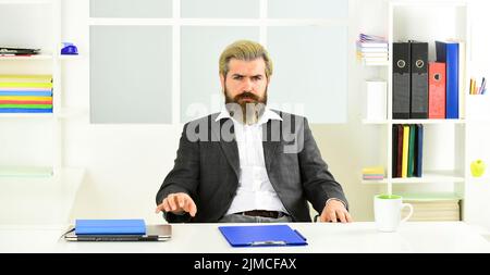Advocacy and jurisprudence. Legal services director. Case manager track paperwork and other important information about case. Man sit office. Business Stock Photo