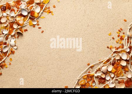 Ambers And Seashells On Sea Sand Background Stock Photo