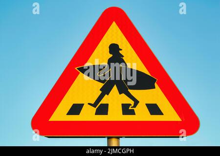 Triangular traffic sign, Caution surfer, Child with baseball cap and surfboard crosses zebra crossing, Lommabukten, Lomma Bay, Oeresund, Skane Stock Photo