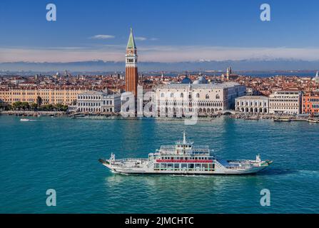 Car ferry in front of the waterfront on the lagoon with Piazzetta, Campanile and Doge's Palace in front of the Alpine chain, Venice, Veneto, Adriatic Stock Photo