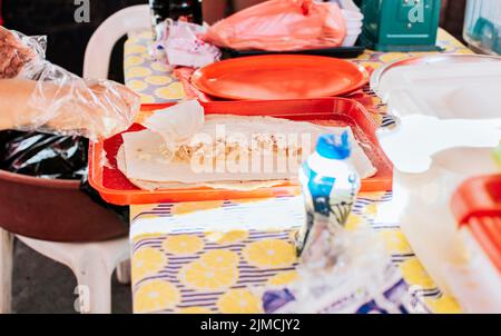 Homemade Nicaraguan quesillo, traditional large quesillo food. Hands making a Nicaraguan quesillo. Close up of hands making a traditional quesillo Stock Photo