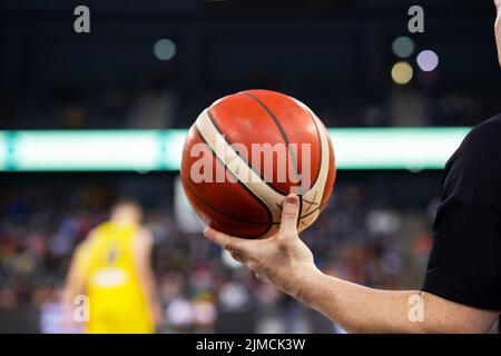 Referee holding basketball during game Stock Photo