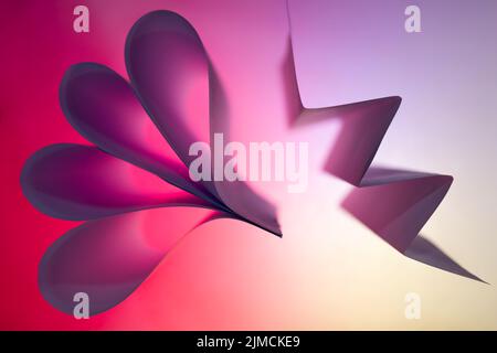 Folded backlit paper abstract shapes suitabe as wallpaper. Stock Photo