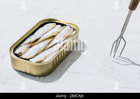 Can of sardines open in half on white background Stock Photo