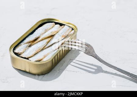 Can of sardines open in half on white background Stock Photo
