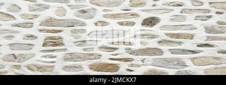 Old stone wall background, seamless ashlar stone wall texture. Stock Photo
