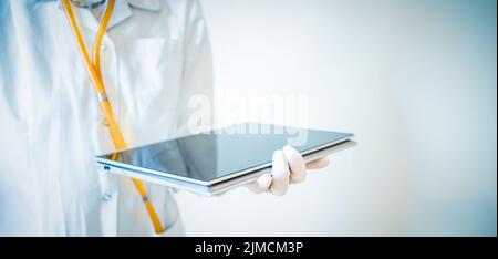 Doctor working on tablet medical care Stock Photo