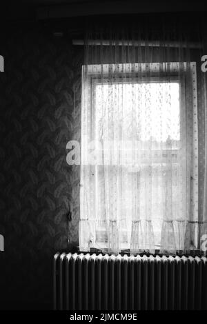 Old window with curtain in black and white Stock Photo