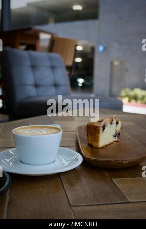 A beautiful cup of coffee with a delicious pastry. Stock Photo