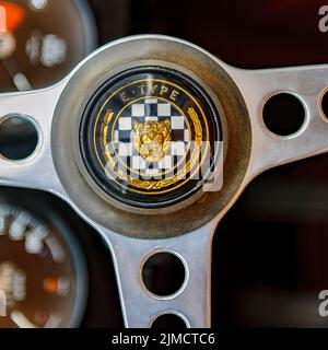Steering wheel of English historic classic sports car classic car roadster Jaguar E with logo emblem head of Jaguar lettering E-Type, fair Techno Stock Photo