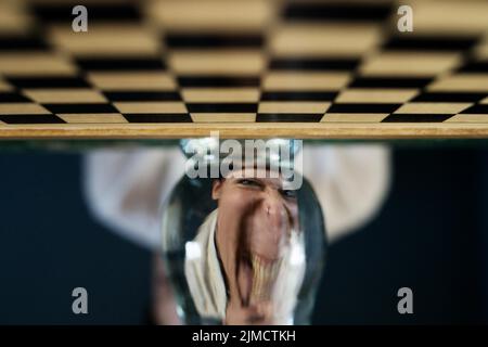 Symbol image, desperation, success, confusion, strategy, chessboard with optical illusion and grimace Stock Photo