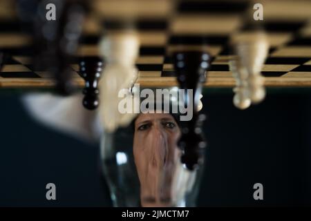 Symbol image, desperation, success, confusion, strategy, chessboard with optical illusion and grimace Stock Photo