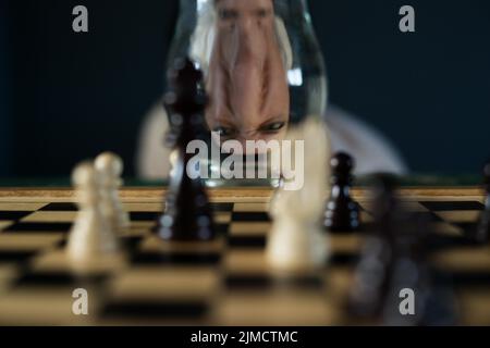 Symbol image, desperation, success, confusion, strategy, chessboard with optical illusion and grimace Stock Photo