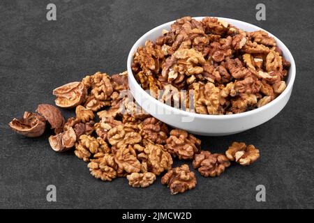 Pile of walnuts on a stone black surface Stock Photo