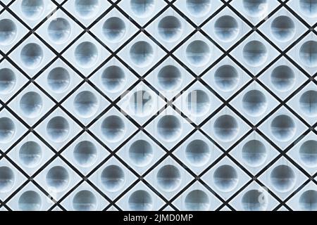 Full frame abstract background facade of modern building with many seamless geometric ornament with diamond shaped elements and many circles Stock Photo
