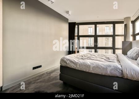 luxury modern and stylish bedroom in a modern house with big windows and king size bed Stock Photo
