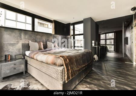 luxury modern and stylish bedroom in a modern house with big windows and king size bed Stock Photo