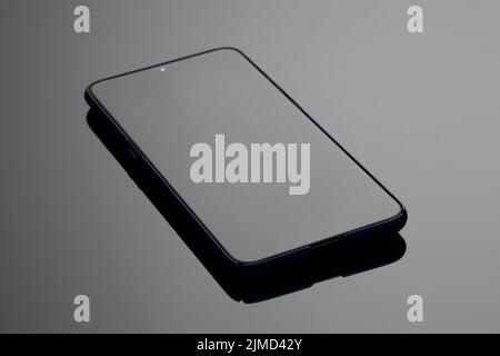 Black large screen smartphone with shadow on glass Stock Photo