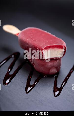 Fruit ice cream stick looks fresh to eat placed on black Stock Photo